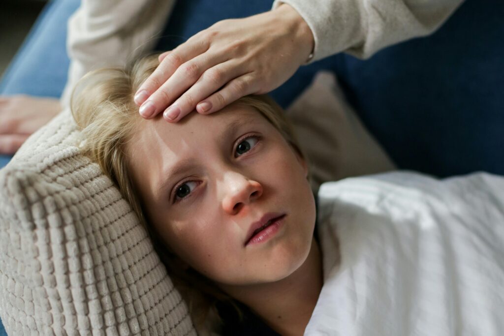 Young child lying down with stomach ache, IBS