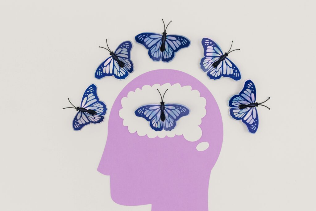 pexels-photo-8849272-8849272 Creative illustration of butterflies representing thoughts over a brain silhouette.